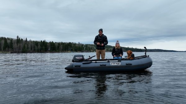 couple and dog fishing on a lake in beautiful British Columbia