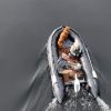 grey inflatable boat with EVA foam on aluminum floor in the lake with man woman and dog