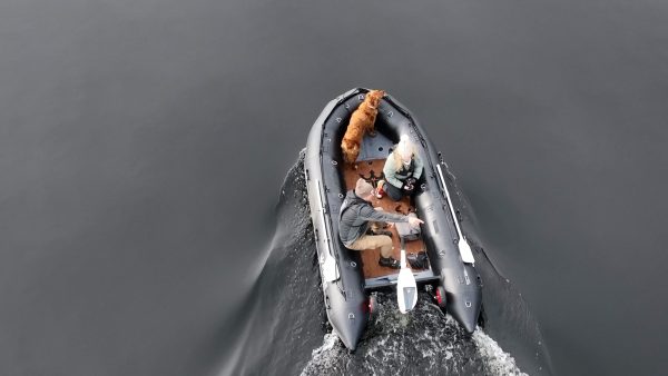 grey inflatable boat with EVA foam on aluminum floor in the lake with man woman and dog