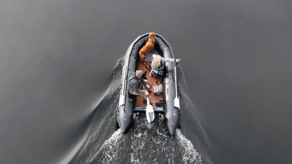 grey inflatable boat with EVA foam on aluminum floor in the lake with man woman and dog