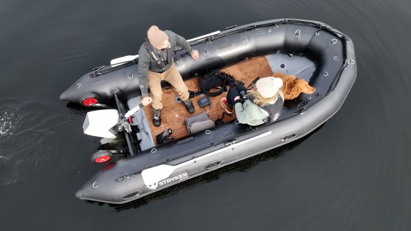 grey inflatable boat with EVA foam on aluminum floor in the lake with man woman and dog