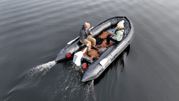 grey inflatable boat with EVA foam on aluminum floor in the lake with man woman and dog