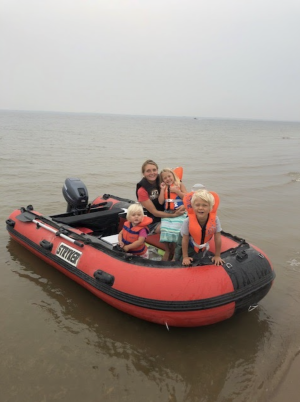 family on a red inflatable boat