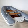 grey inflatable rigid hull inflatable boat with EVA foam on bench seats and floor. bow locker in front of boat also covered in Eva foam