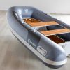 grey inflatable rigid hull inflatable boat with EVA foam on bench seats and floor. bow locker in front of boat also covered in Eva foam