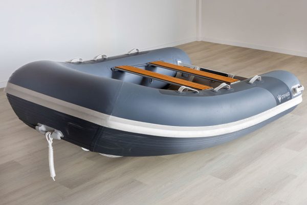 grey inflatable rigid hull inflatable boat with EVA foam on bench seats and floor. bow locker in front of boat also covered in Eva foam