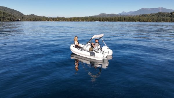 white tender yacht dinghy cruising on the water