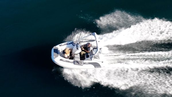 white tender yacht dinghy cruising on the water