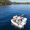 white tender yacht dinghy cruising on the water