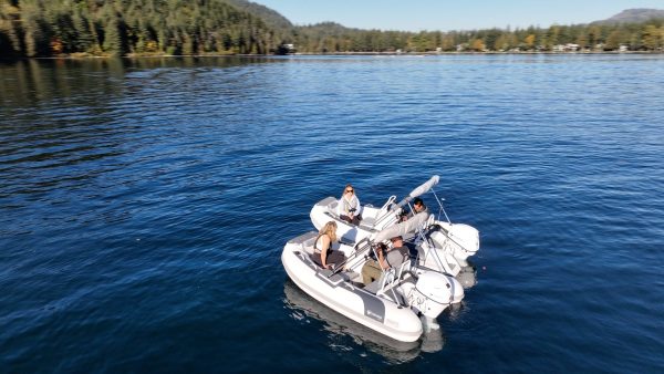 white tender yacht dinghy cruising on the water