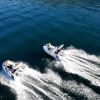 side by side white tenders yacht dinghy cruising on the water