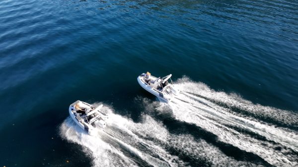 side by side white tenders yacht dinghy cruising on the water