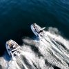 side by side white tenders yacht dinghy cruising on the water