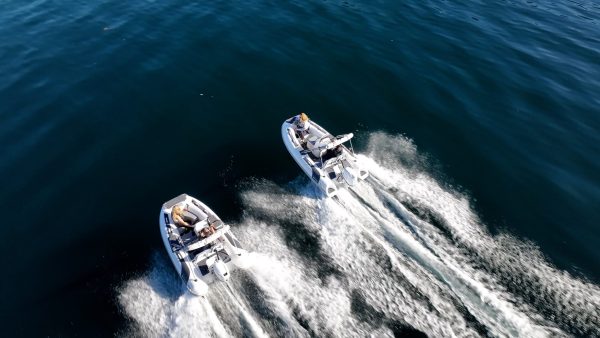 side by side white tenders yacht dinghy cruising on the water