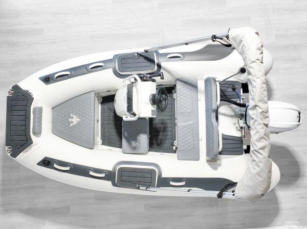 over head white rigid hull inflatable boat with bimini, integrated console and tohatsu outboard