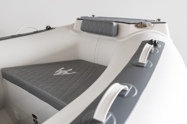 close up of bow seat on white inflatable rigid hull boat.