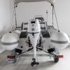 white rigid hull inflatable boat with bimini, integrated console and tohatsu outboard on road runner trailer