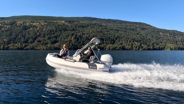 white tender yacht dinghy cruising on the water