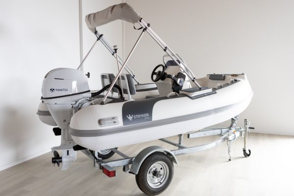 white rigid hull inflatable boat with bimini, integrated console and tohatsu outboard