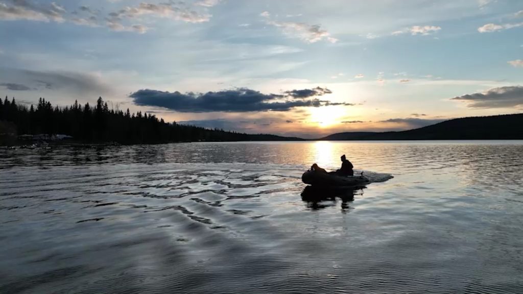 Inflatable boat on a lake with a beautiful sunset