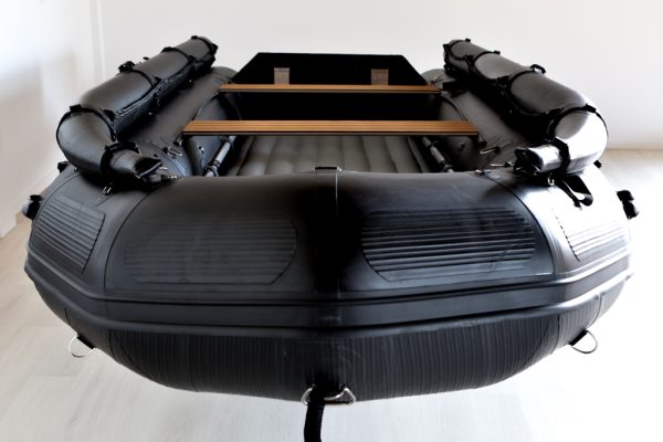 bow view stealth black inflatable jet boat in showroom